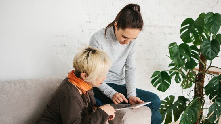 A young girl explains to an elderly woman about Advance Care Planning