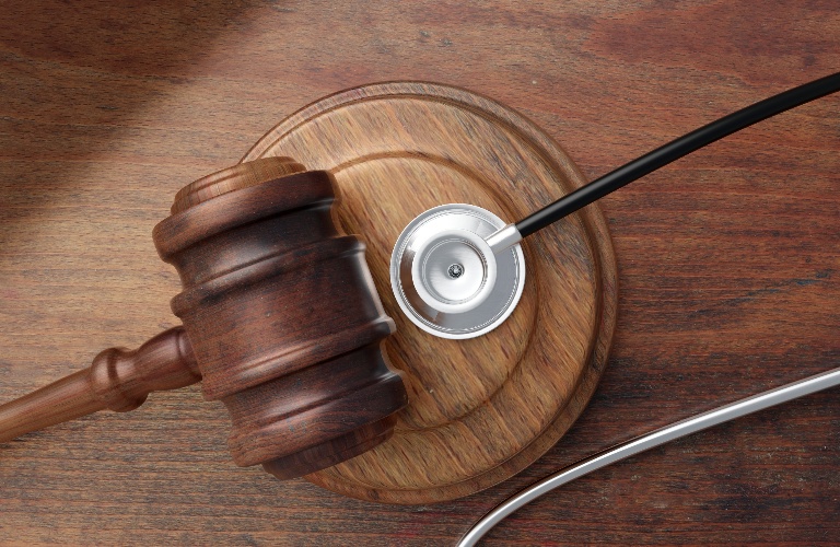 Judge's gavel and doctor stethoscope