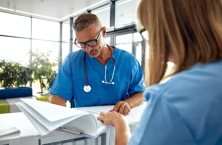 nurse showing doctor paperwork