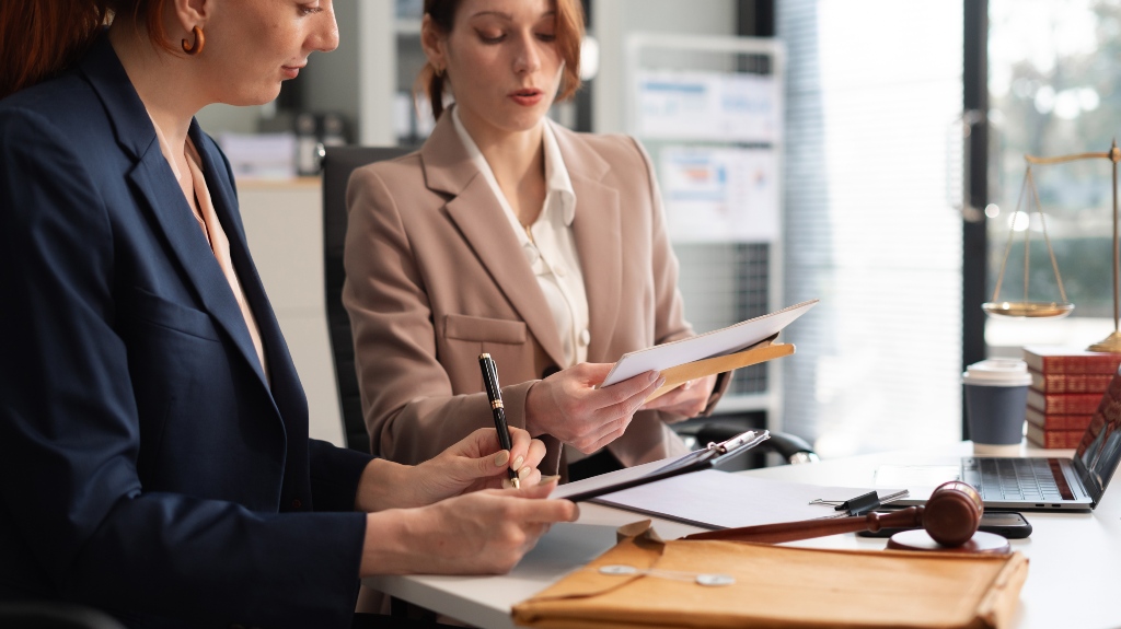 Lawyers and business professionals discuss contract papers at the office